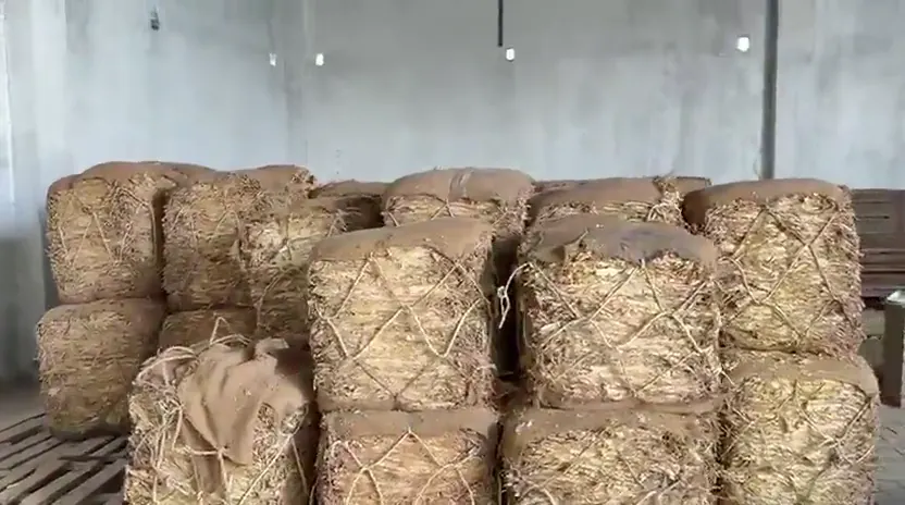 Baled leaf stacked on pallets in a storage hall